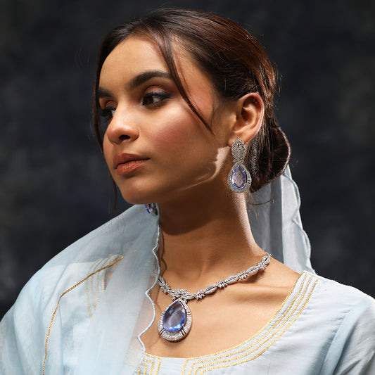 A woman wearing Imperial Elegance American Diamond Necklace (Blue) with Earrings.