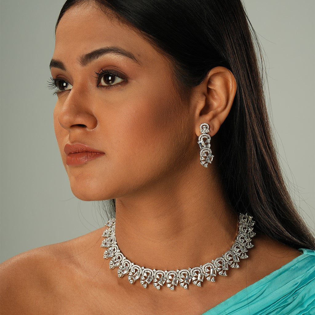 A woman wearing Infinite Swirl American Diamond Necklace Set with Earrings (Rodium).