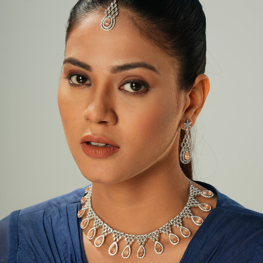 A woman wearing Peach Colored American Diamond Glowing Droplet Necklace.