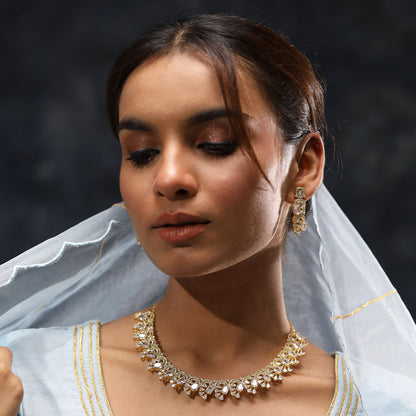 A woman wearing Infinite Swirl Radiance American Diamond Necklace (Gold) with Earrings.