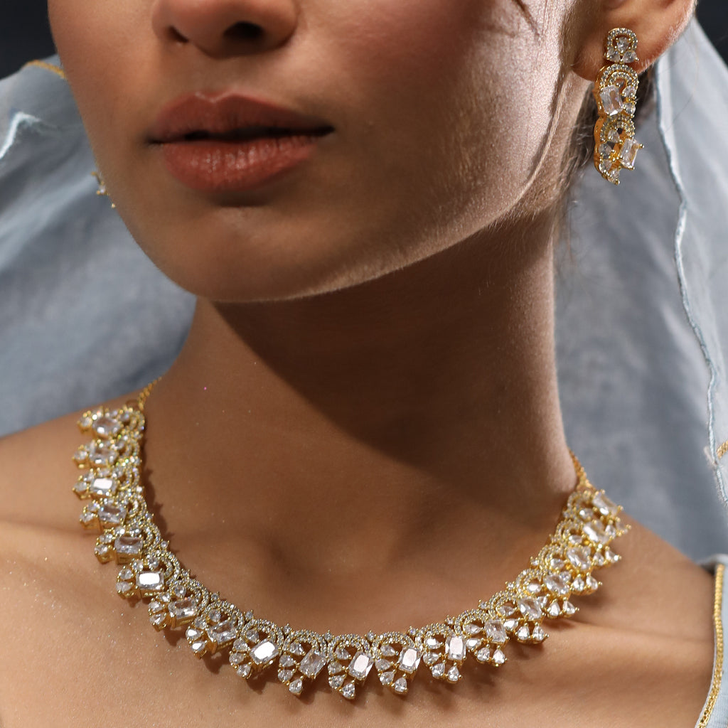 A woman wearing Infinite Swirl Radiance American Diamond Necklace (Gold) with Earrings.