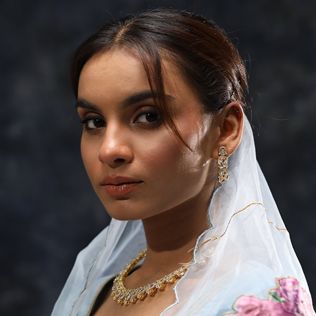 A woman wearing Infinite Swirl Radiance American Diamond Necklace (Gold) with Earrings.