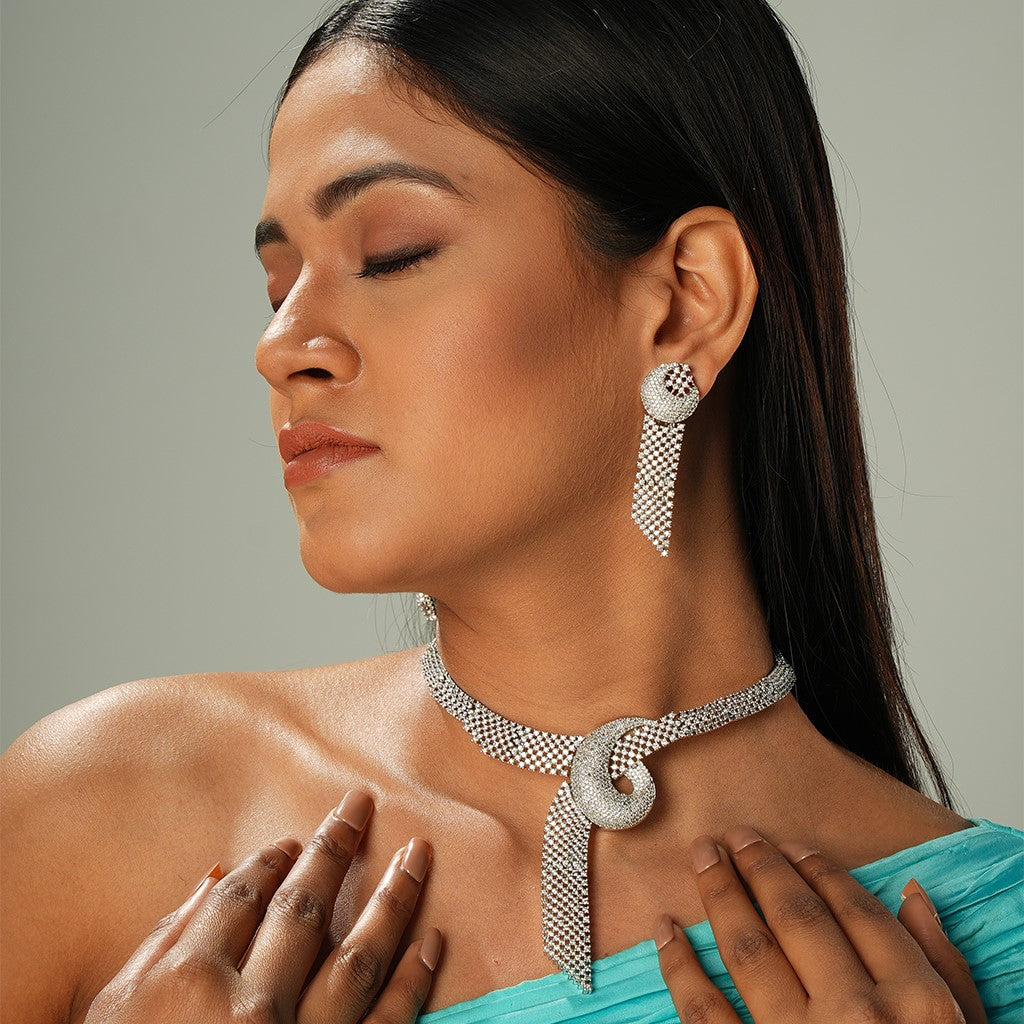 A woman wearing Shimmering Knot Ensemble Necklace Set (Rhodium Plating) with Earrings.